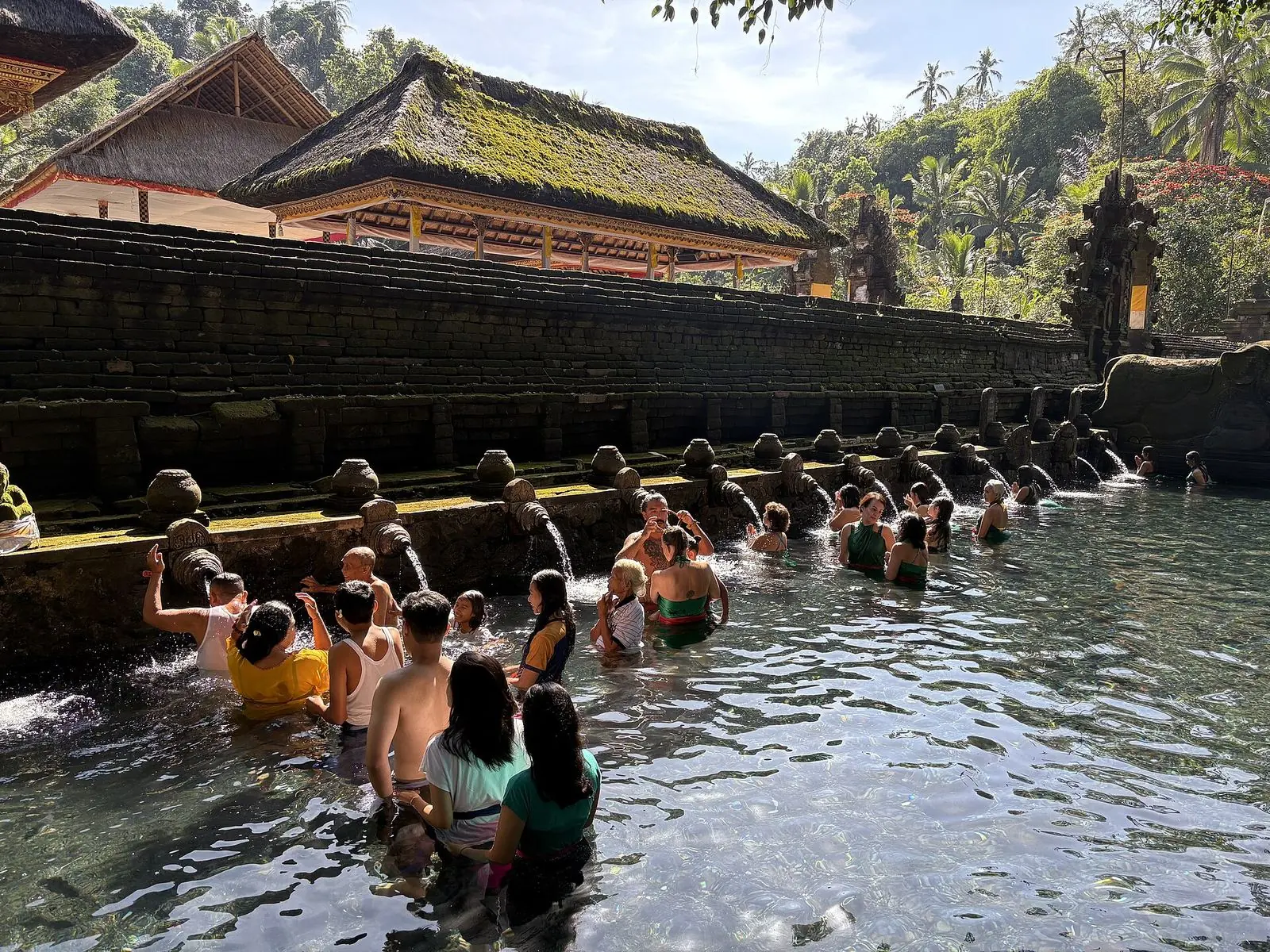 Visitors in the holy spring pools of Tirta Empul