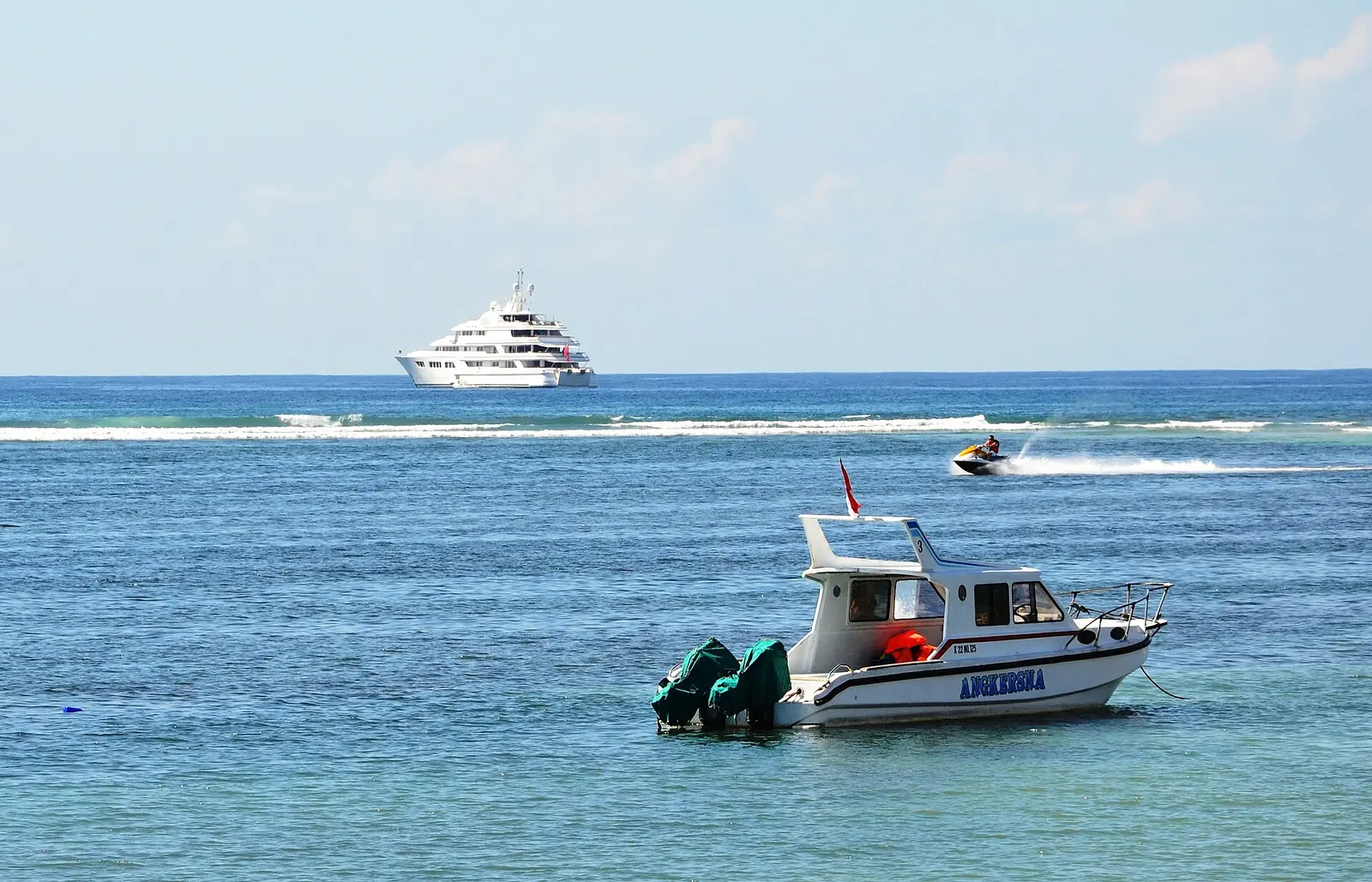 A jet ski and a boat on the calm water at Tanjung Benoa